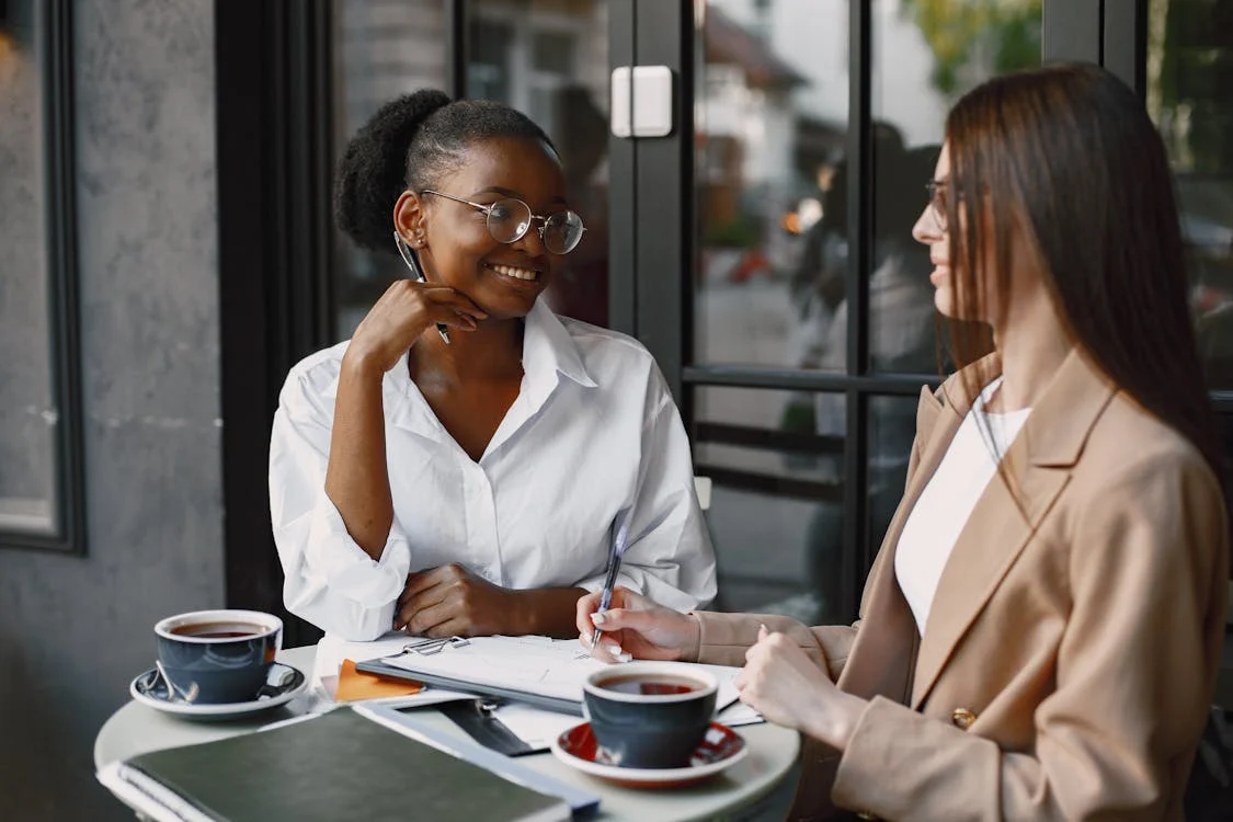 Two women networking over coffee